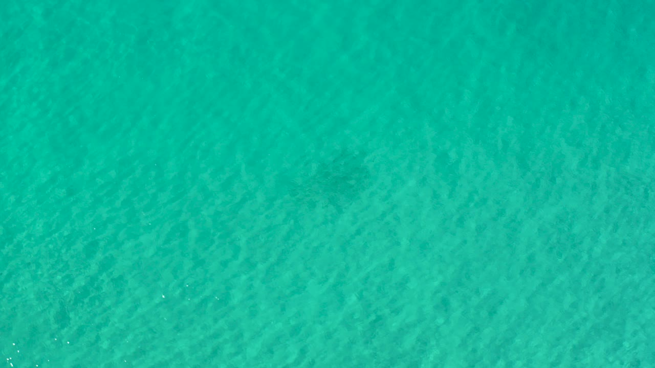 Turquoise water surface with small ripples