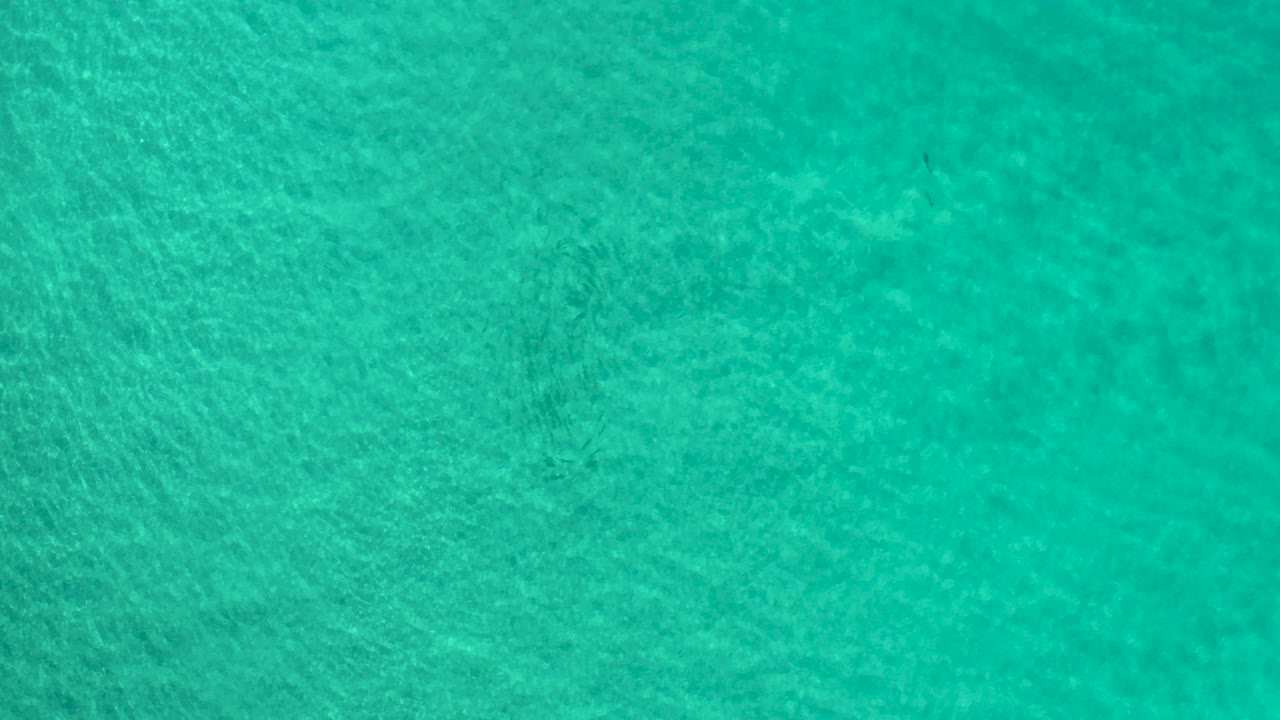 Turquoise ocean water with pale ripple patterns.