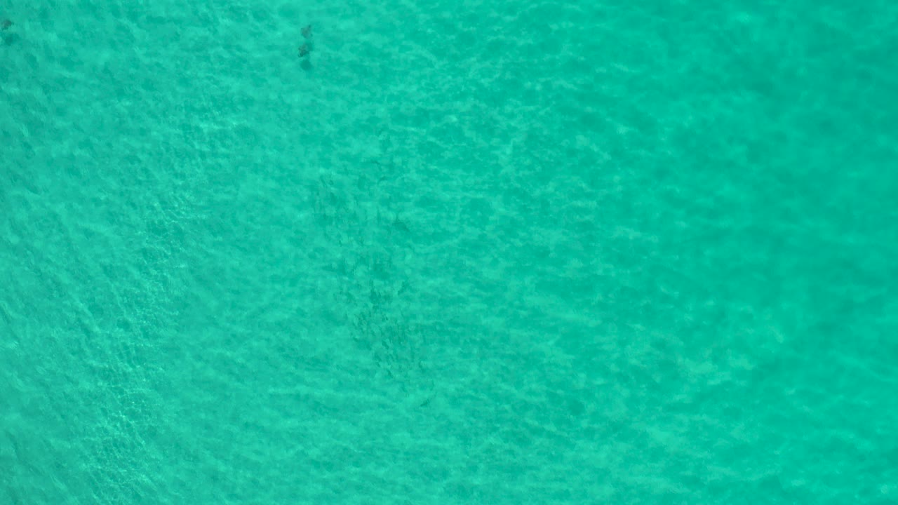 Turquoise ocean water with faint dark patches