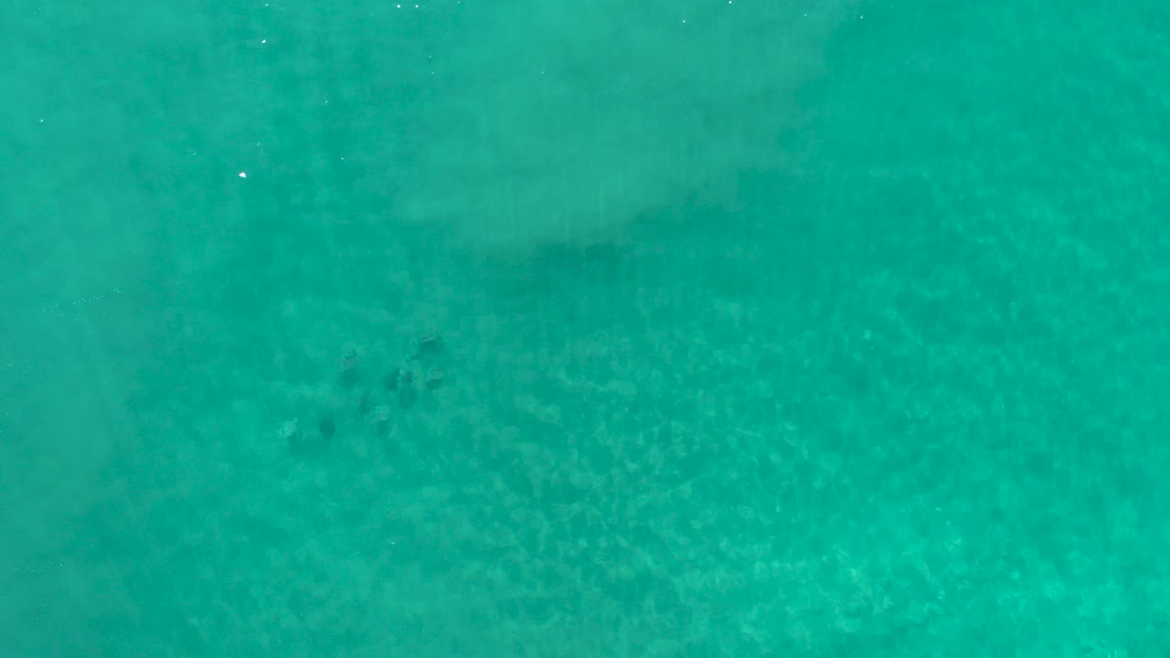 Overhead turquoise ocean with faint wave bands