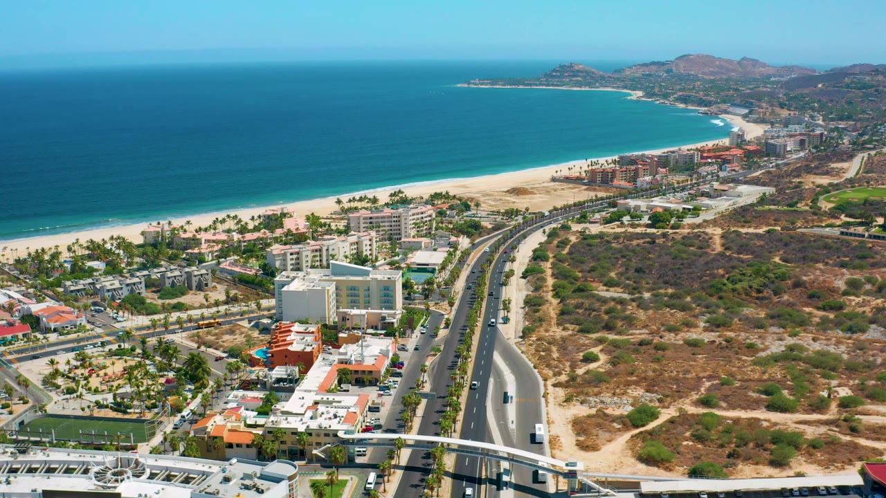 Aerial coastline with mid-rise buildings and light traffic