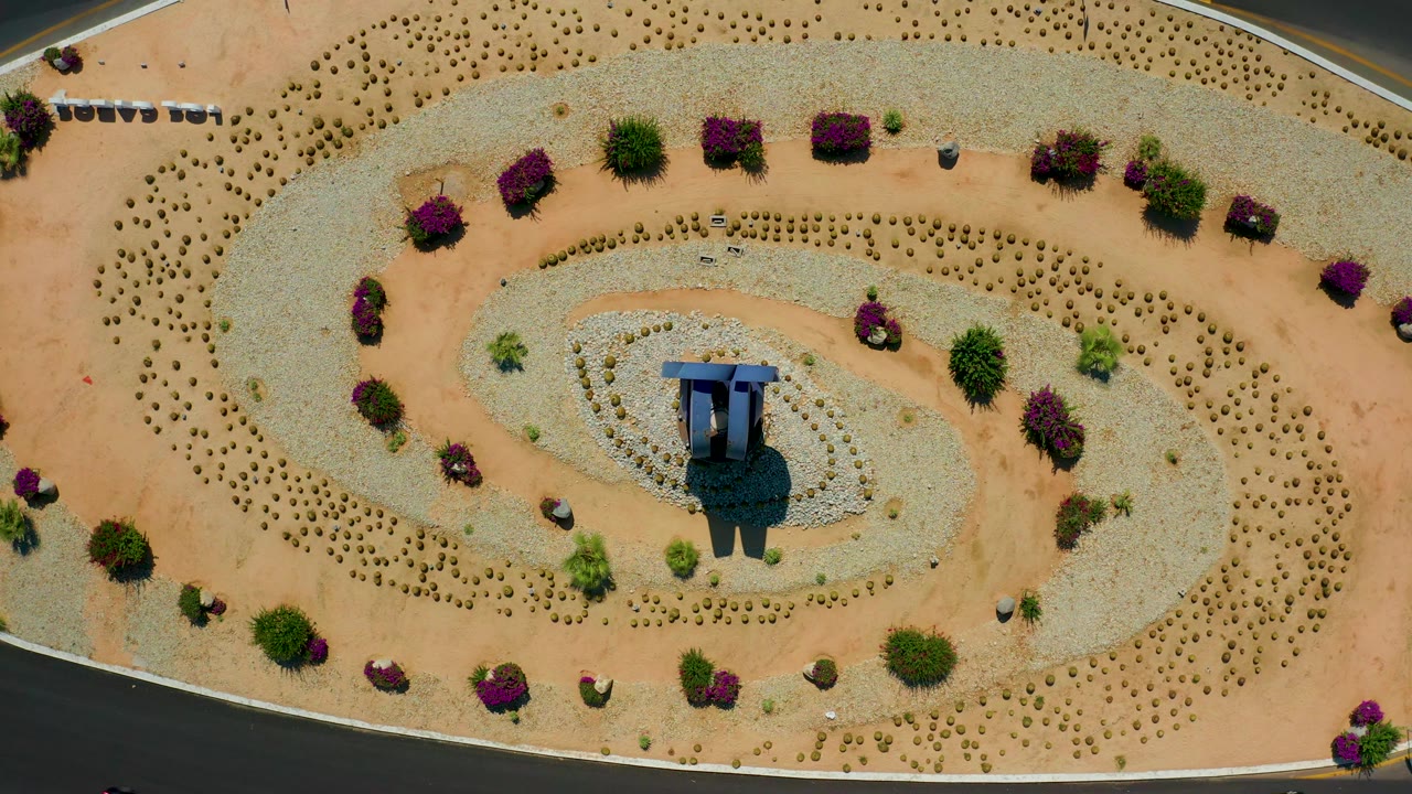 Aerial view of spiral planting patterns and a central blue structure