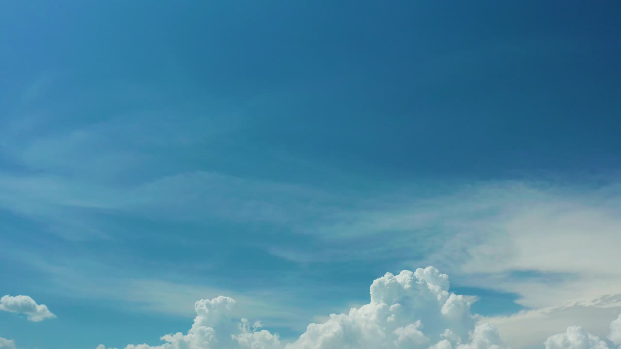 Soft blue sky with cloud mass along the lower frame.
