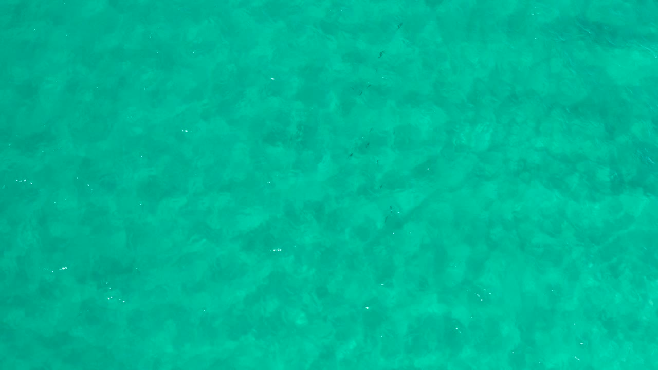 Top-down view of clear turquoise ocean water