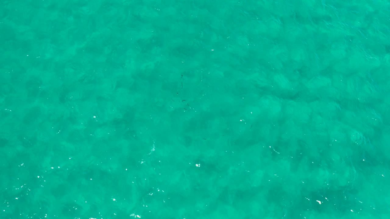 Turquoise ocean surface viewed from above