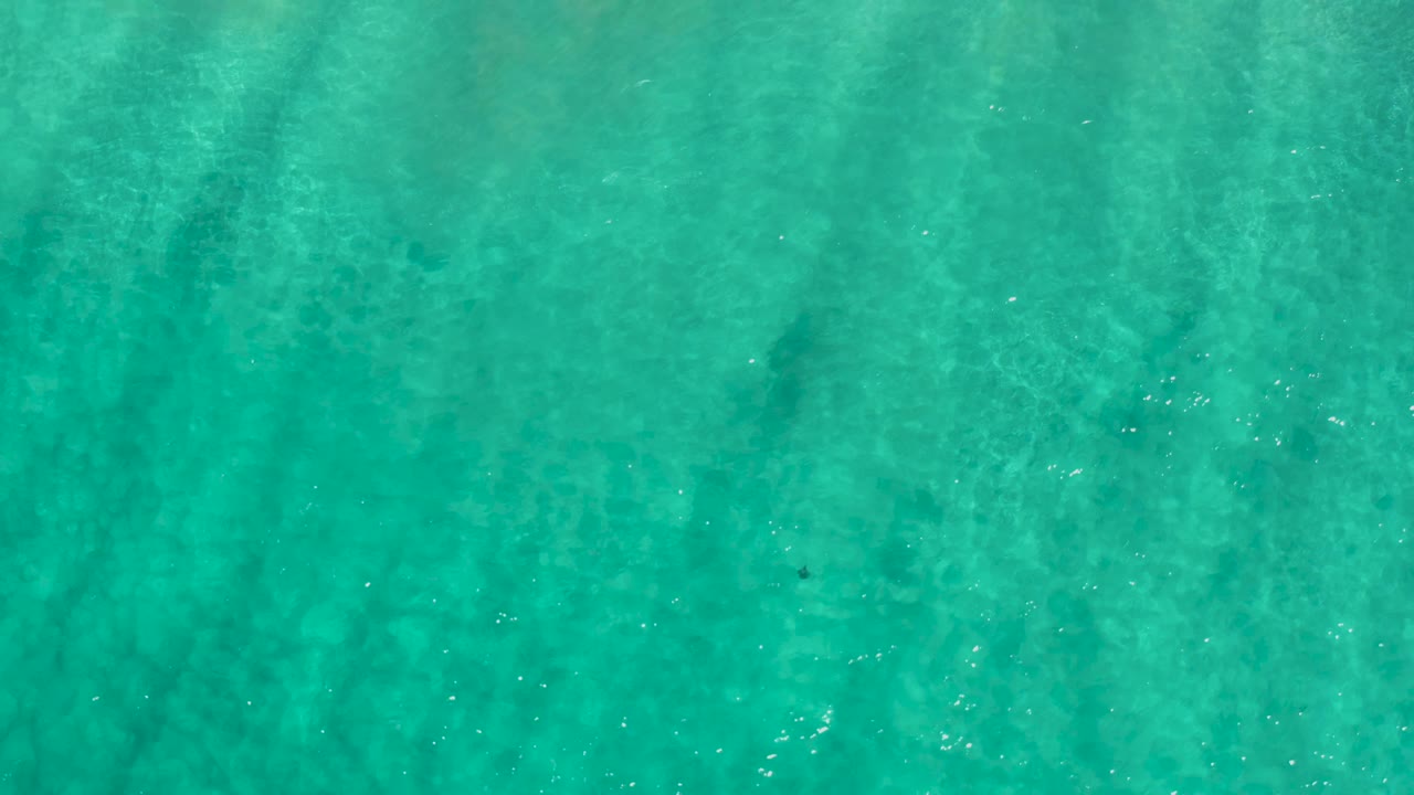 Clear turquoise ocean surface in Los Cabos, Mexico, with soft tonal variation below the water and no visible people.