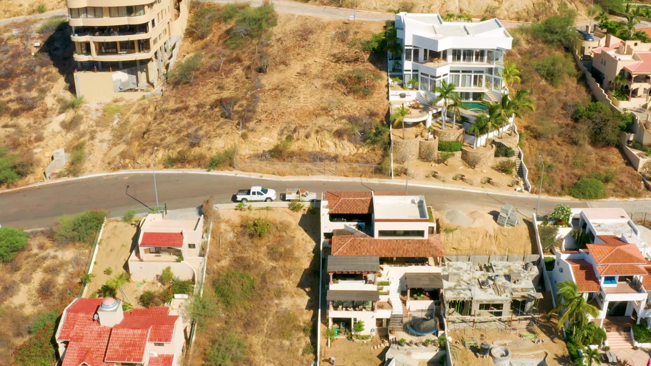 Overhead view of hillside mansions and road