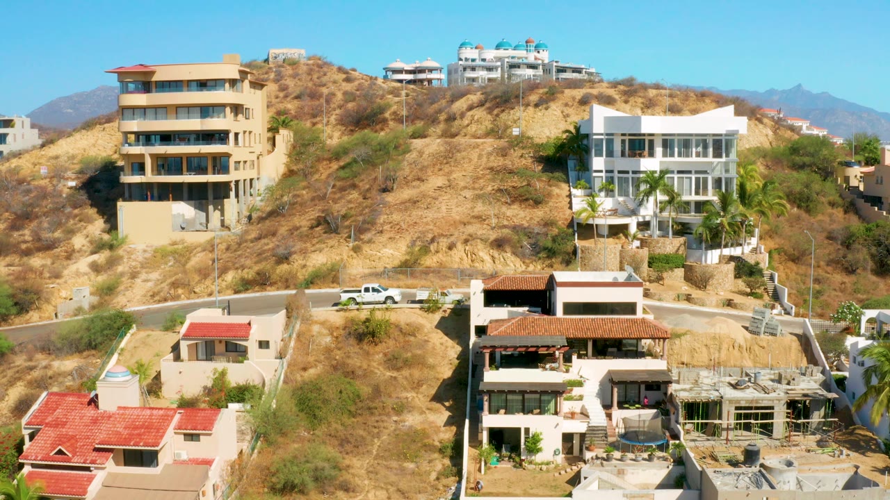 Wide view of hillside residences and blue sky