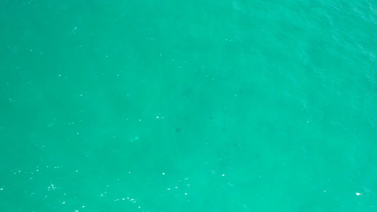 Turquoise ocean surface seen from above.