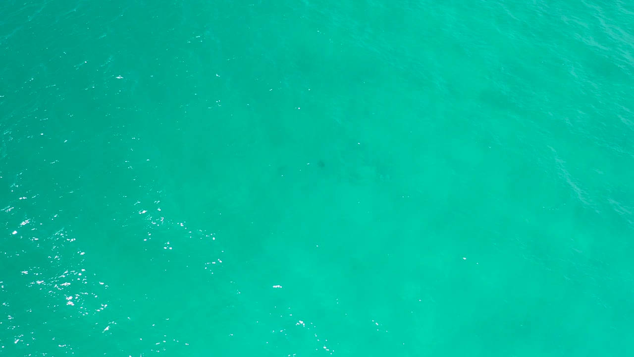 Overhead view of turquoise seawater in San Jose Del Cabo with soft surface ripples and no visible people.