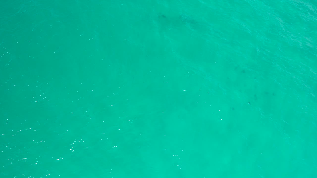 Turquoise sea water in San Jose Del Cabo fills the frame with small bright ripples and no visible people.