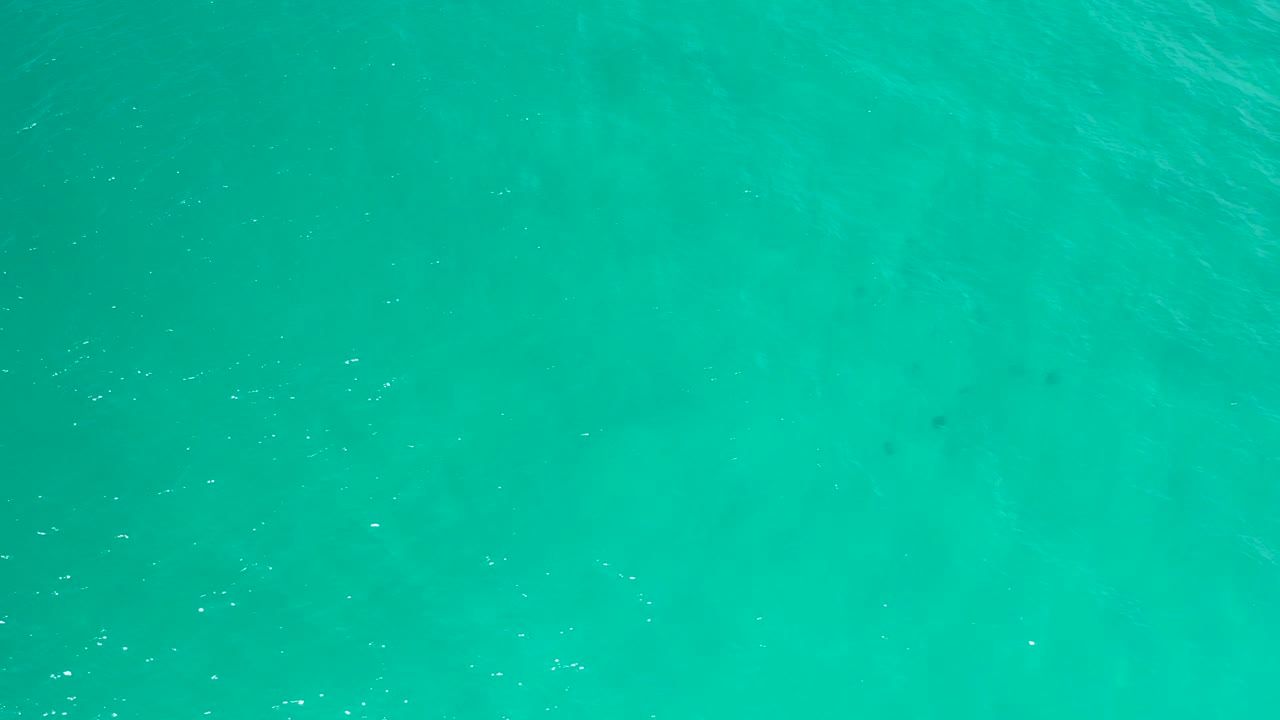 Blue-green sea water in San Jose Del Cabo shows small sparkling highlights across the surface and no visible people.