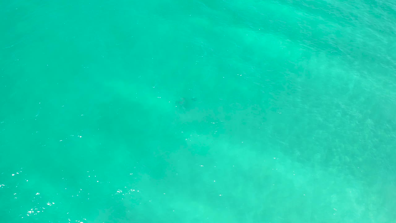 Clear turquoise ocean in San Jose Del Cabo, Mexico, with a slightly darker underwater area near the top and no visible people.