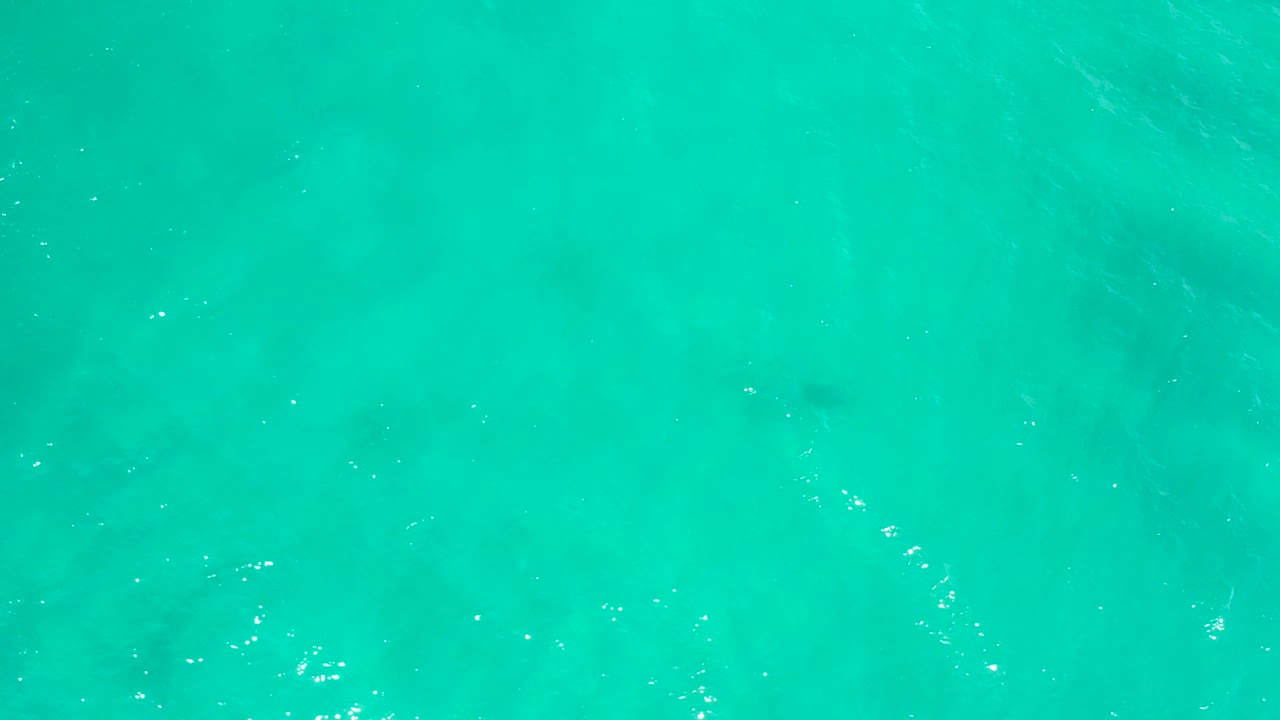 Clear turquoise water in San Jose Del Cabo, Mexico, with subtle underwater shadowing and small ripples across the frame, no visible people.
