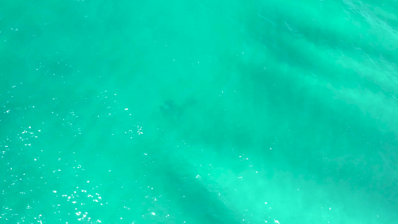 Clear green-blue water with light ripples