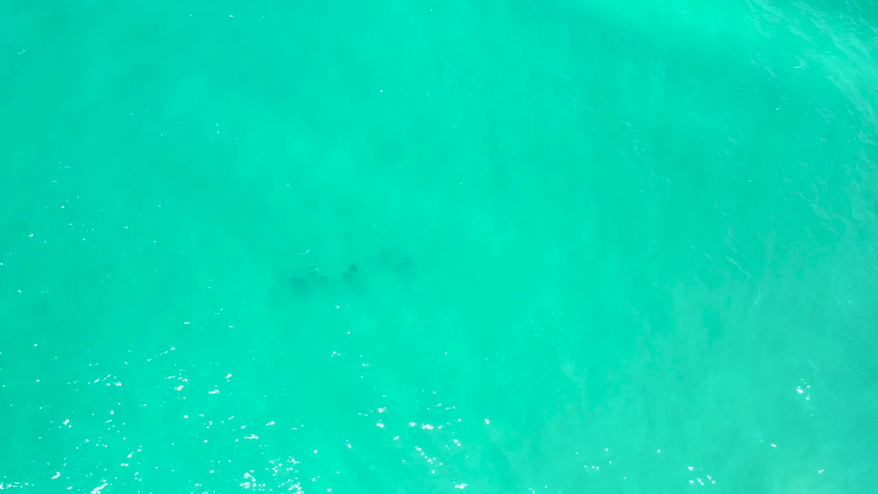 Turquoise water fills the frame in San Jose Del Cabo, Mexico, with soft surface ripples, scattered reflected light, and no visible people.