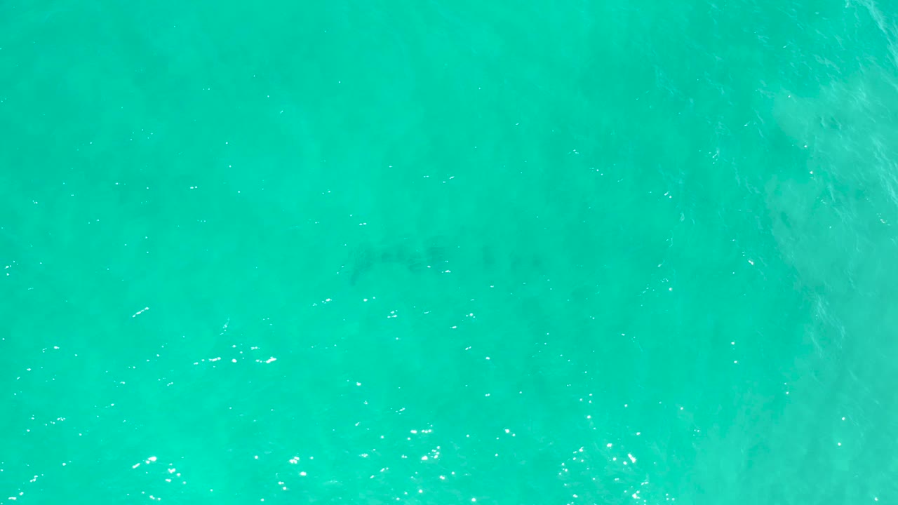 Aerial view of blue-green ocean in San Jose Del Cabo, Mexico, with faint darker underwater patches and no visible people.