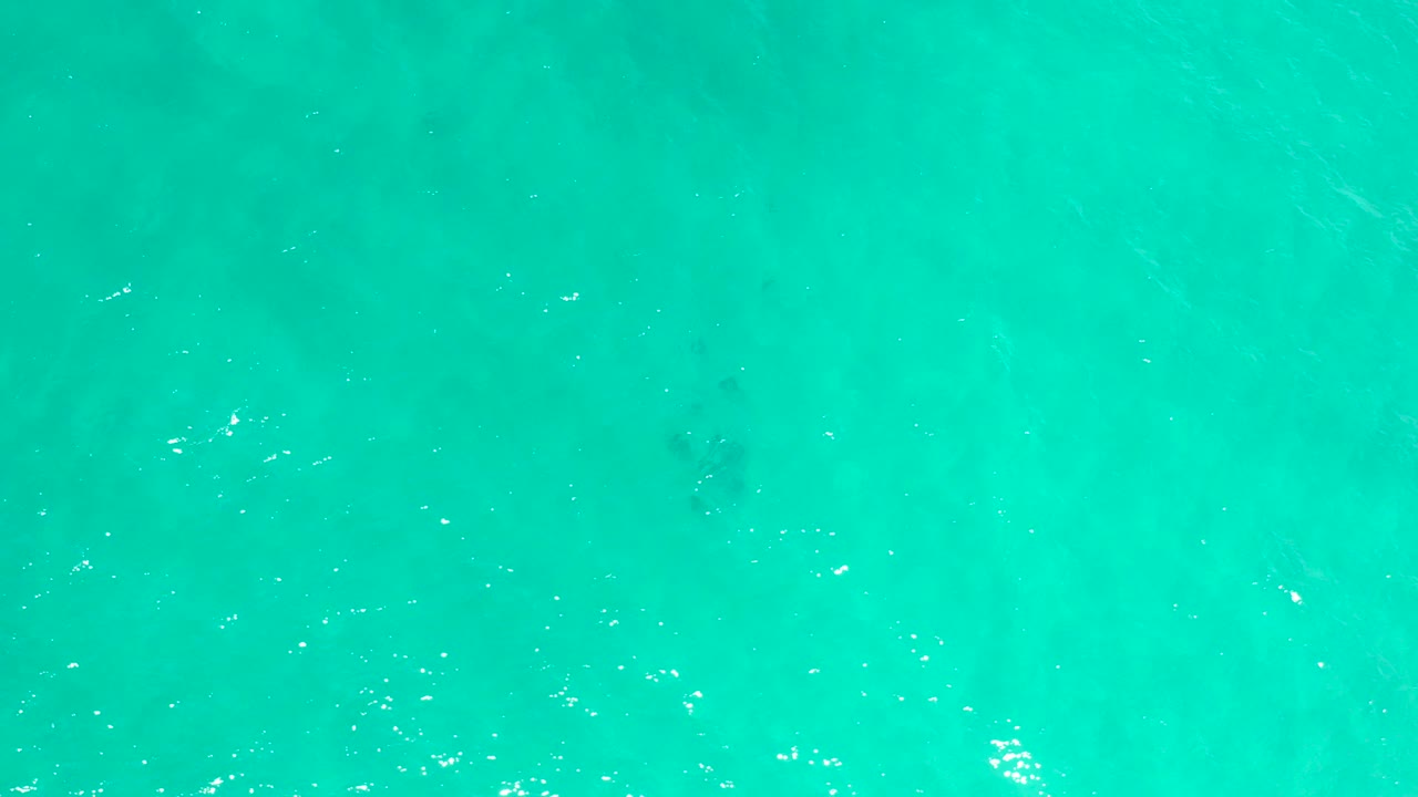 Overhead view of turquoise sea water in San Jose Del Cabo, Mexico, with fine surface ripples and no visible people.