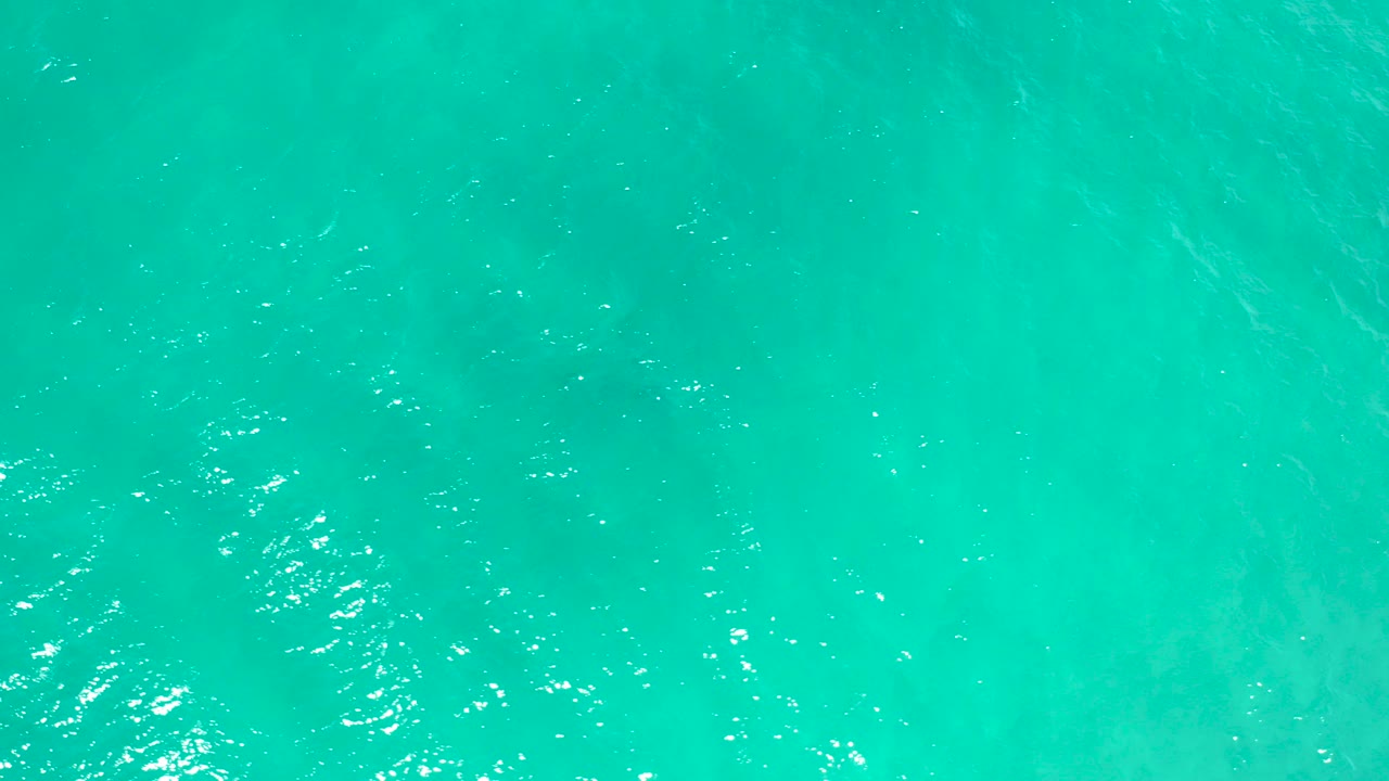 Overhead teal ocean water with small ripples