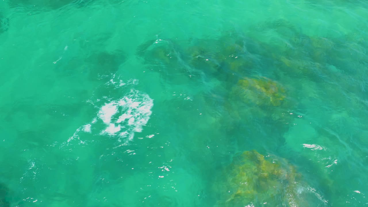 Clear shallow water with rocks below the surface