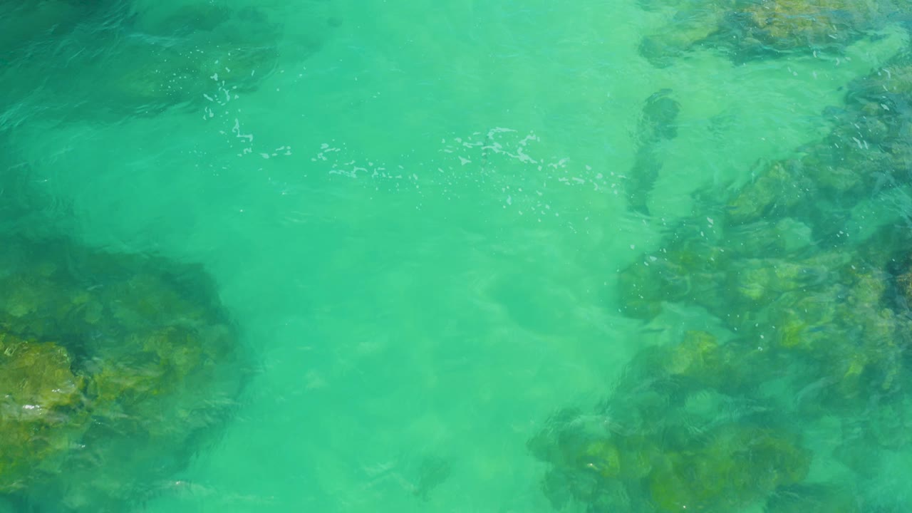Translucent waves over a rocky underwater patch