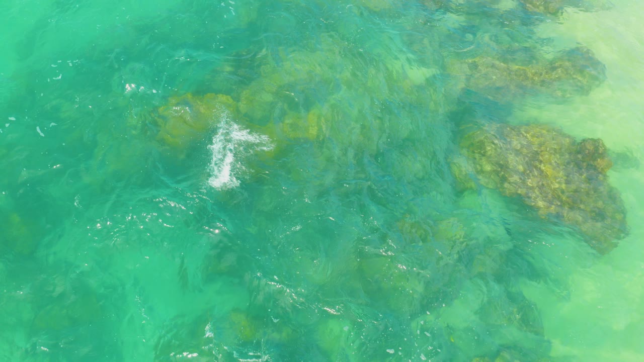 Turquoise water over submerged reef rocks