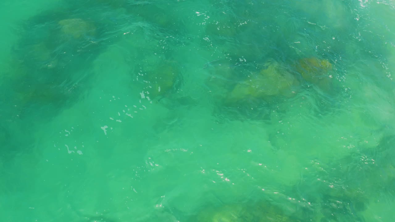 Green-blue water with rocks beneath the surface