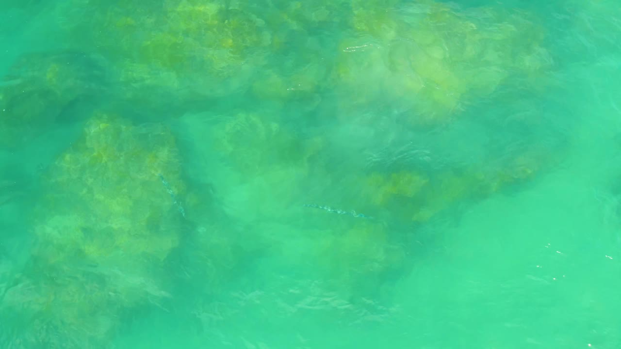 Soft ripples over underwater rock formations.