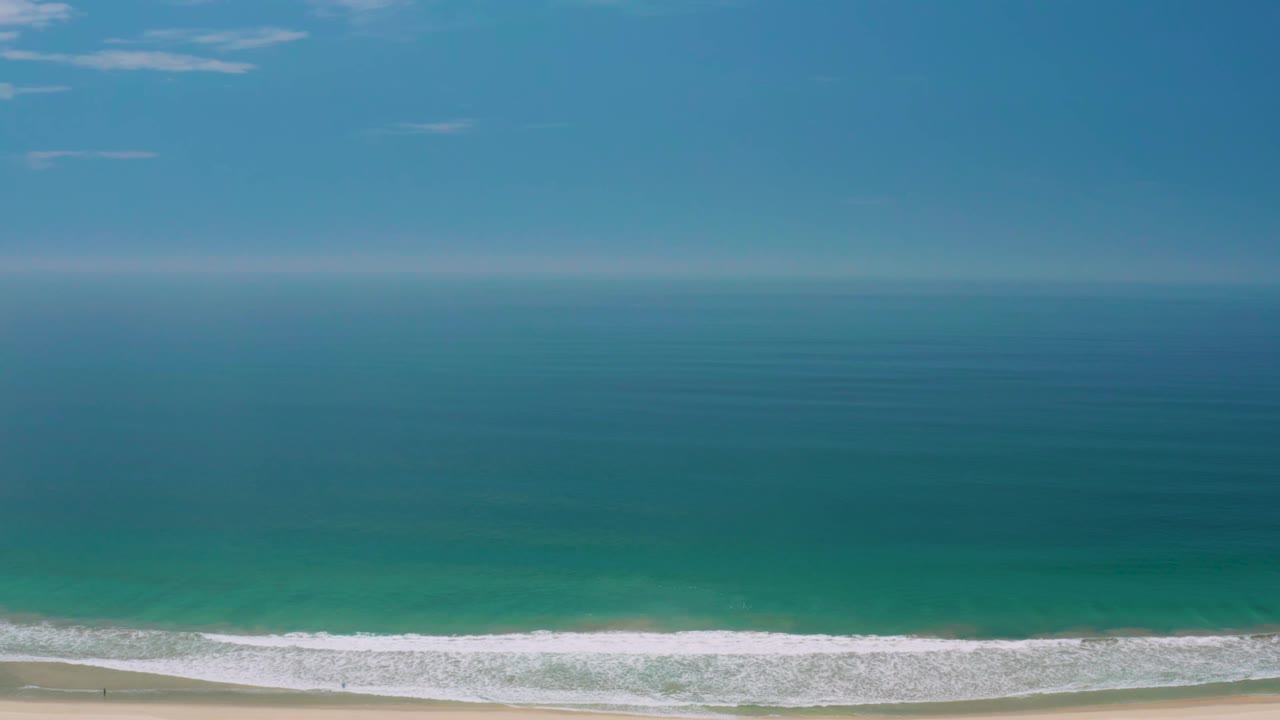 Palmilla Beach ocean view with the horizon high in frame, deep blue water offshore, greener water near shore, a white wave band, and no visible people.