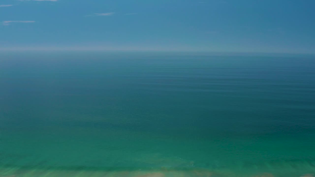 Palmilla Beach sea and sky view with turquoise water in the lower frame, deeper blue water toward the horizon, and no visible people.