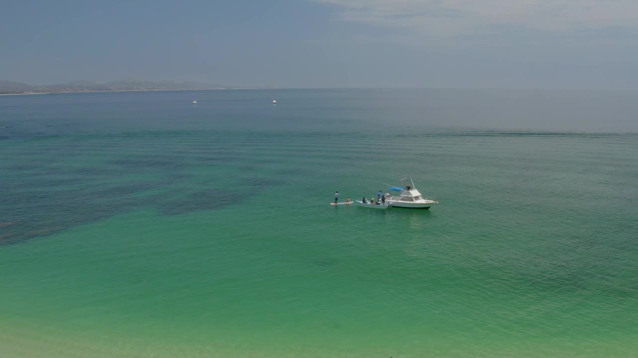 Small white boat crossing clear green water