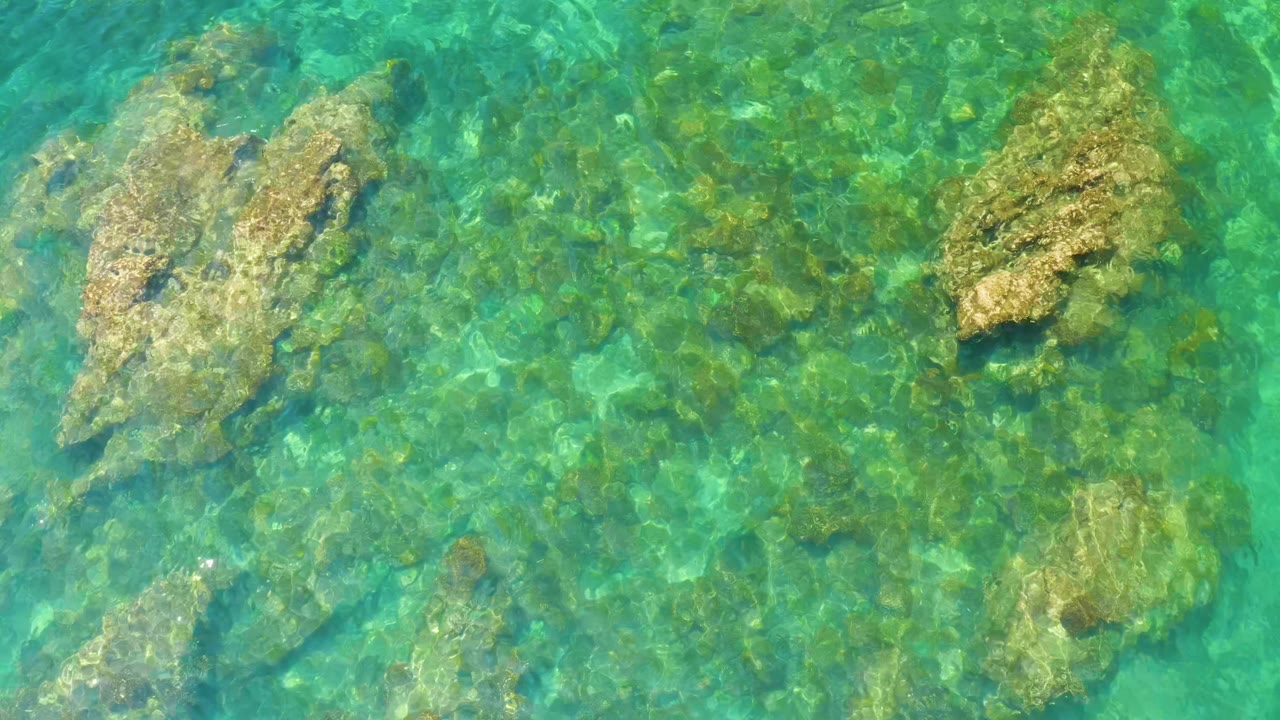 Shallow green-blue water with rocky seabed