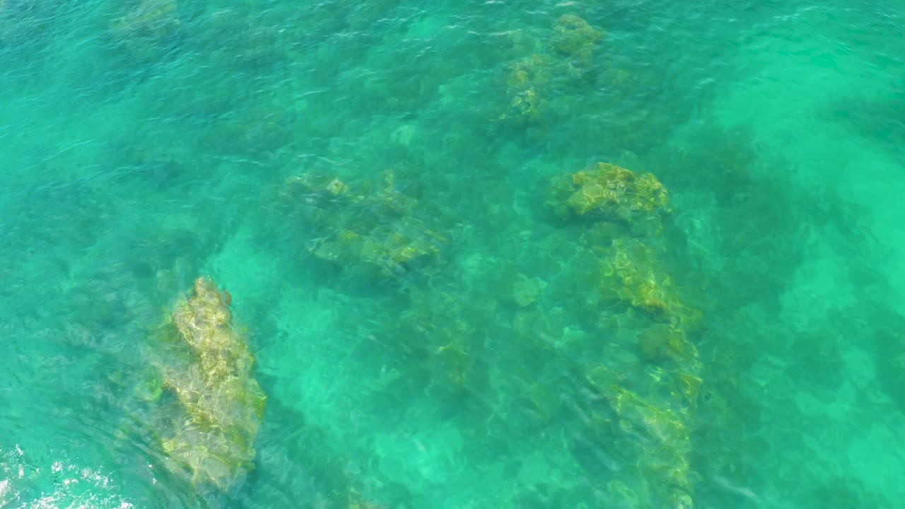Clear water with pale rock and ripples