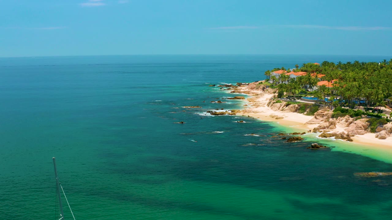 Wide ocean foreground with Palmilla Beach and palms to the right