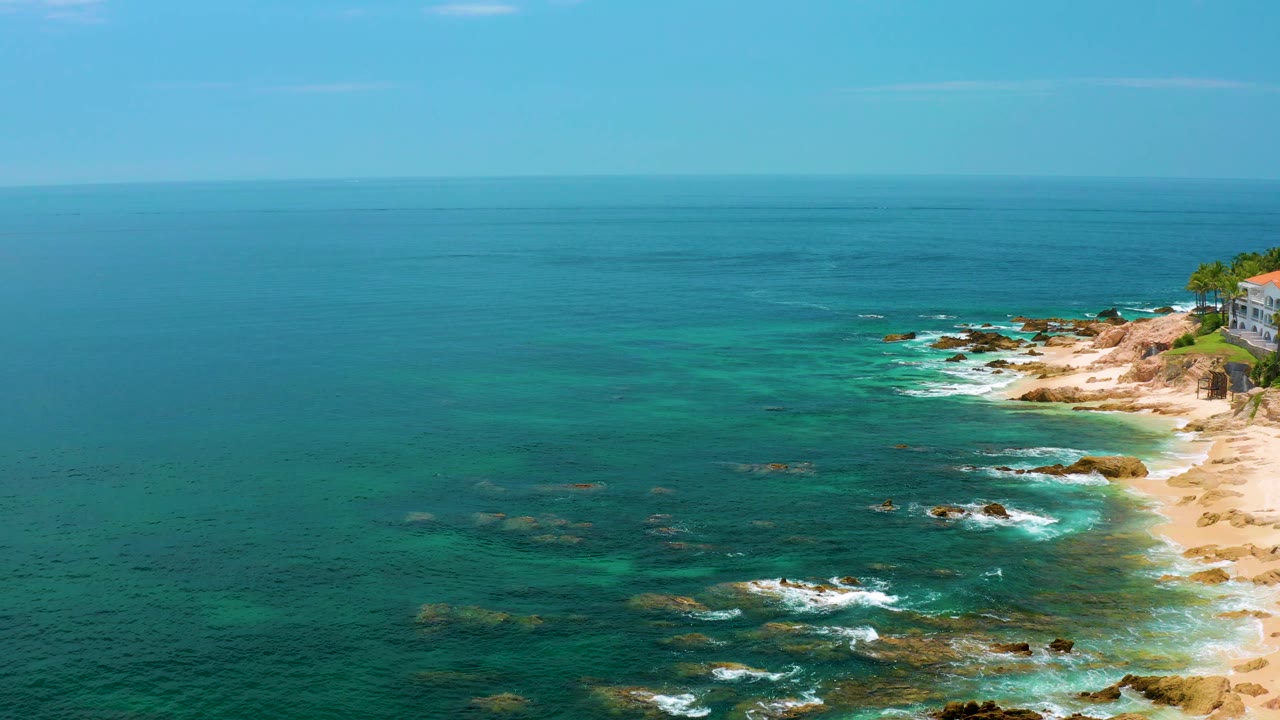 High coastal view with sea filling the frame and shoreline on the right.