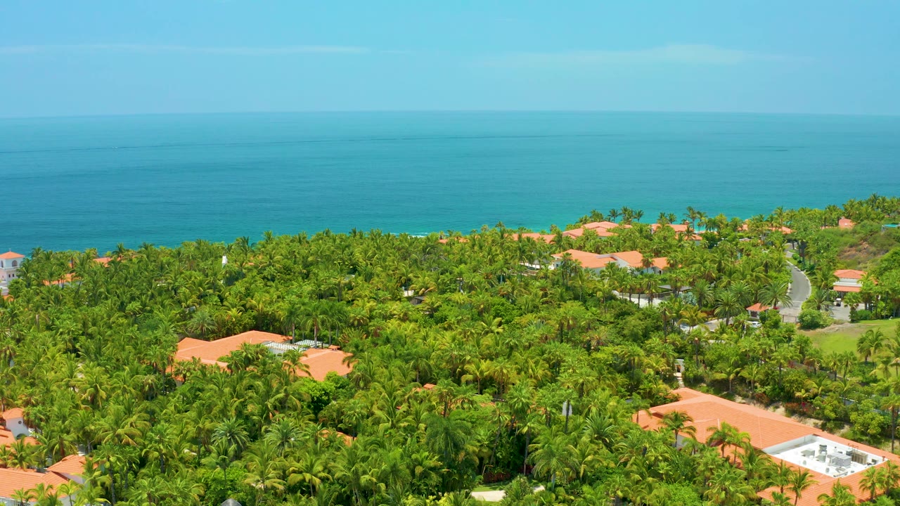 Aerial coastal greenery with road and distant sea