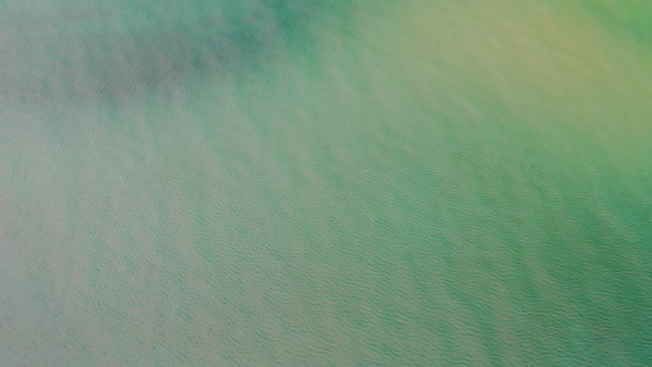 Soft turquoise surface with cloudy green streaks.