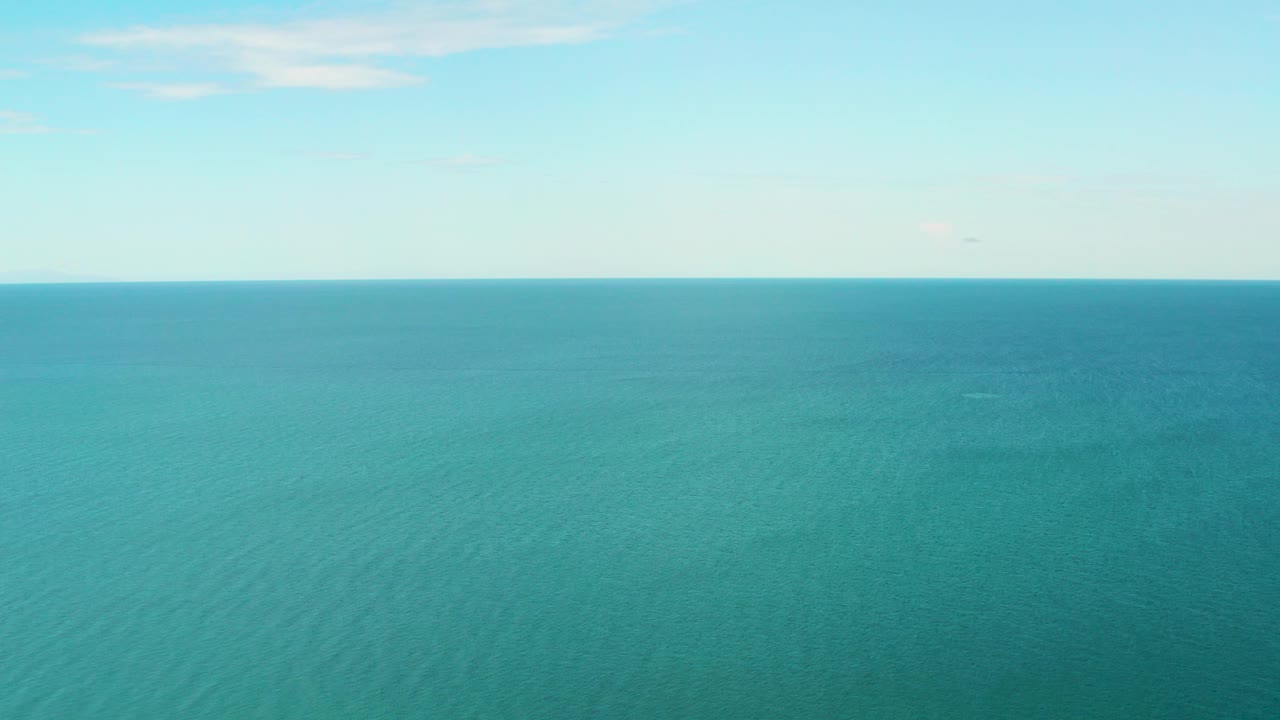 Wide view of turquoise sea and pale sky in La Ribera, Baja California Sur, Mexico, with a level horizon and no visible people.