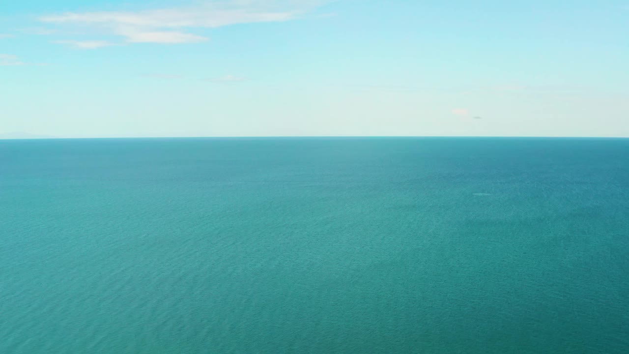 Open sea with faint clouds above the horizon