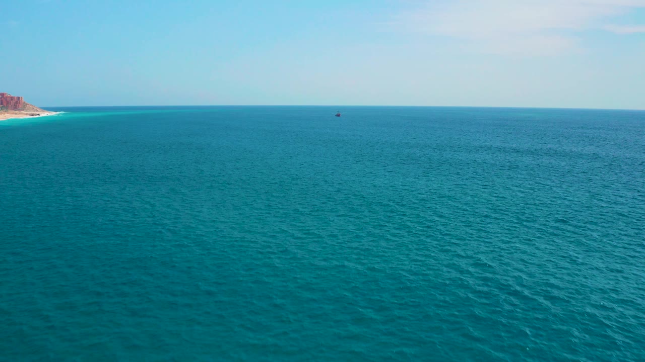 Third frame holds a wide ocean view at Secrets Marquis Los Cabos, Mexico, with rippled water, pale sky, the left coastline edge, and no visible people.