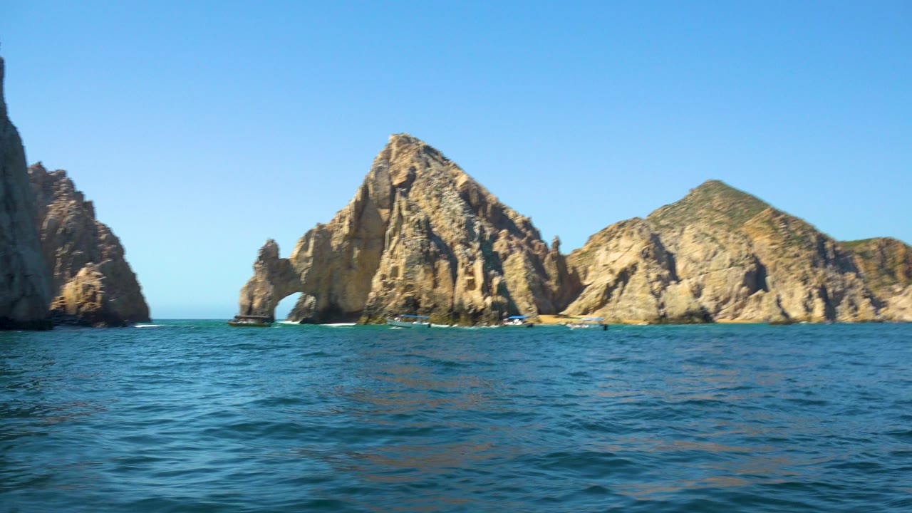 Ocean foreground with tall cliff edge and rocky arch