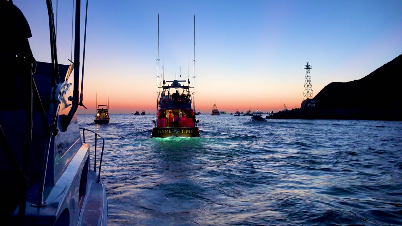 Neon-lit boat ahead on choppy dusk water