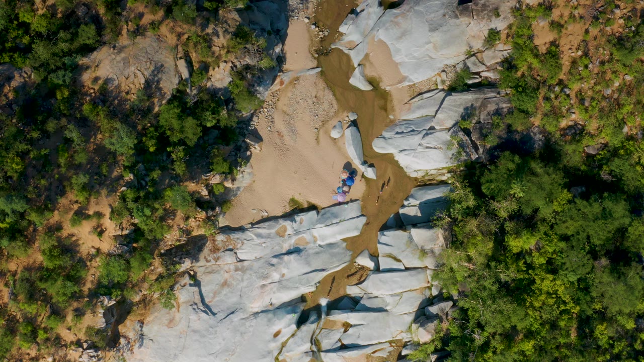 Aerial view of shallow water crossing white rock and sand.