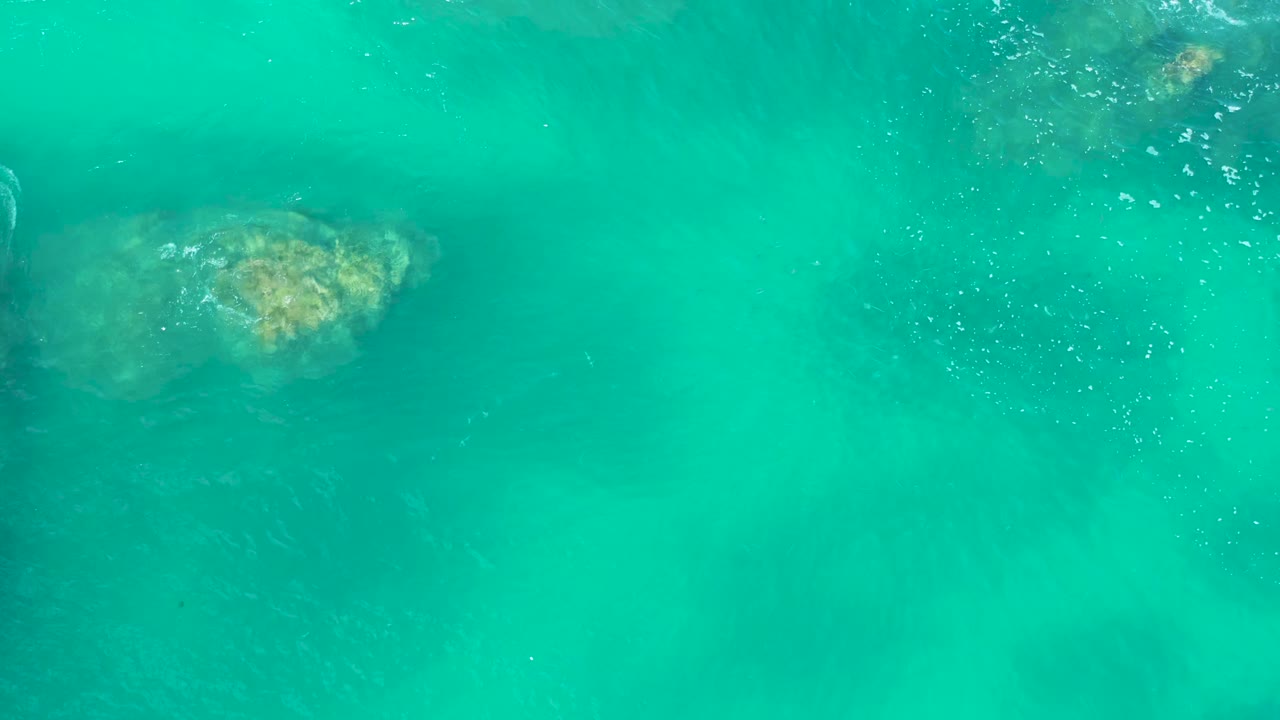 Clear water with underwater rock and surface bubbles