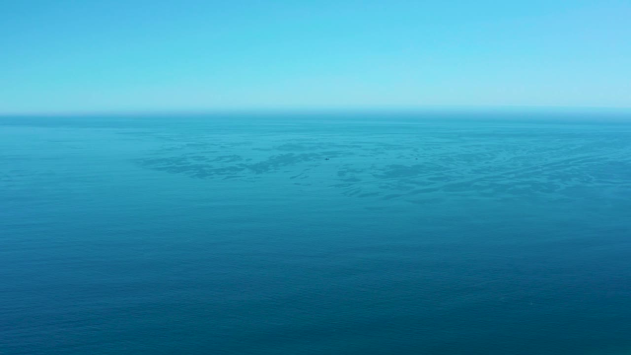 At two seconds, the Marquis Los Cabos ocean view shows open blue water with faint surface texture, a distant horizon, and no visible people.