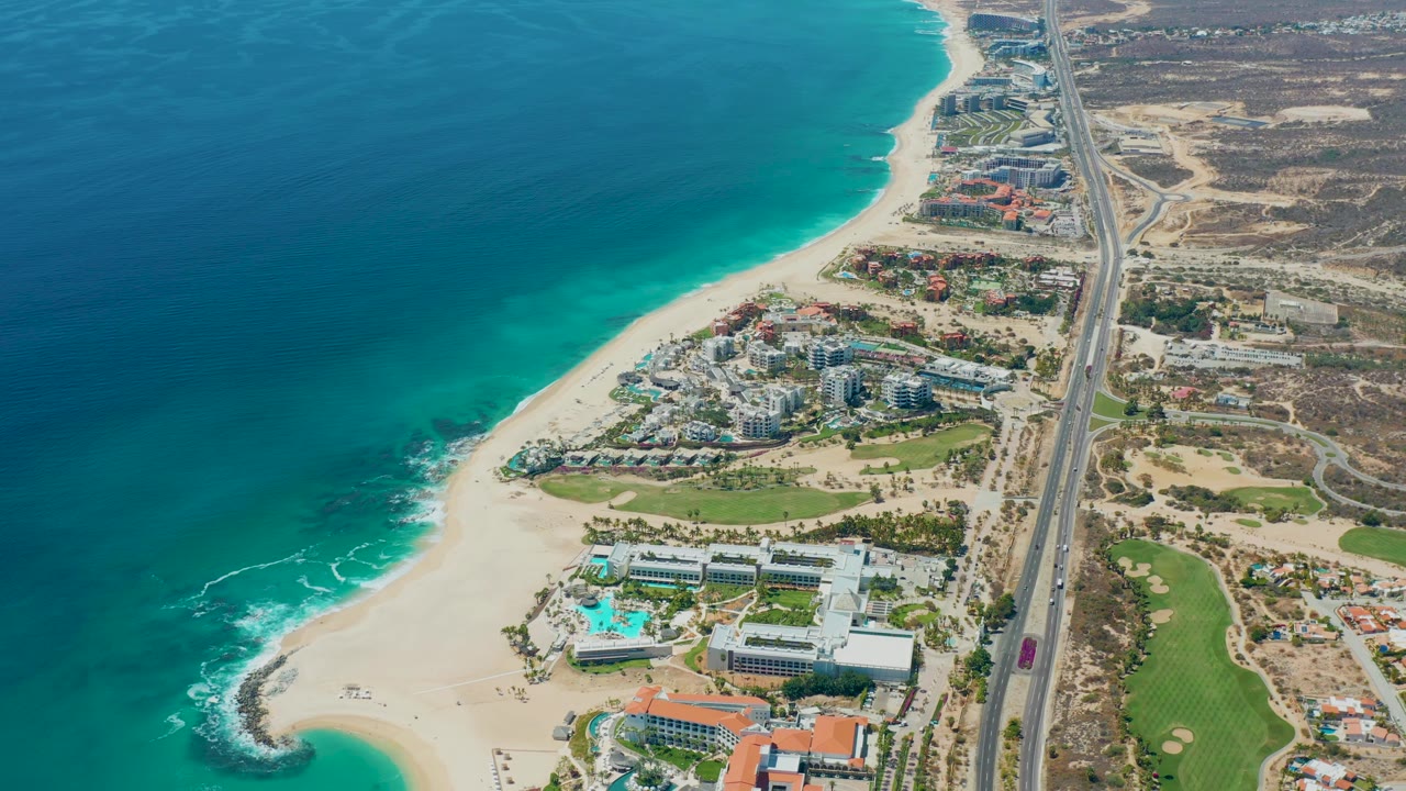 Overhead coastal development beside beach and highway