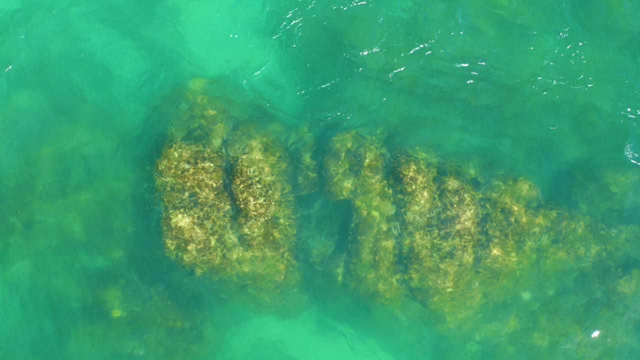 Turquoise water over submerged rock formations