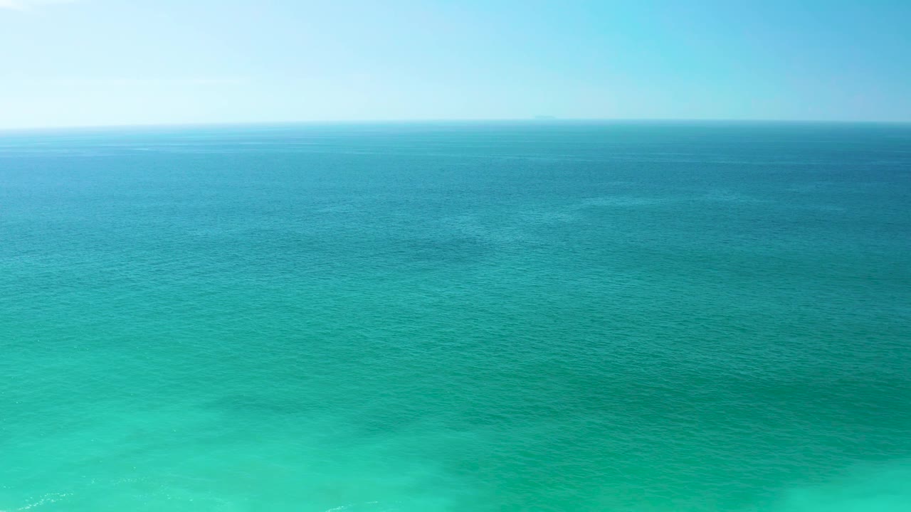 Second frame shows the Dreams Los Cabos ocean surface shifting from bright turquoise foreground to darker blue midwater below a clear sky, with no visible people.