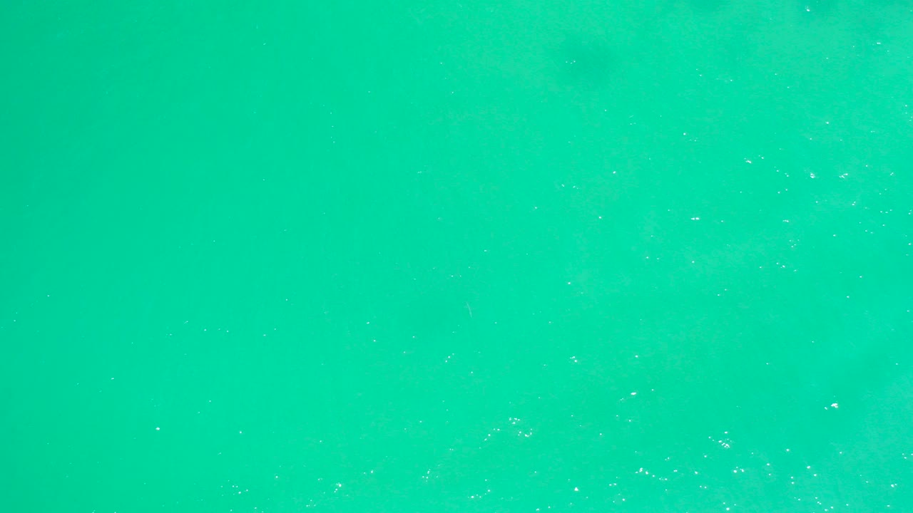 Clear turquoise ocean surface at Dreams Los Cabos with faint texture and no visible people.