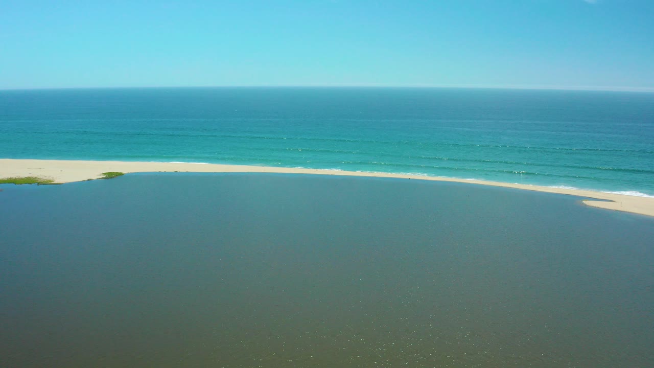 Aerial view of a sandy spit between lagoon and ocean